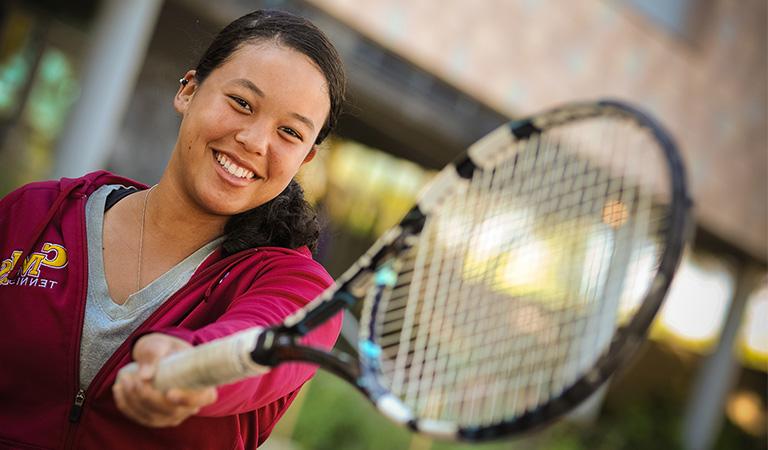 Student holding tennis racquet